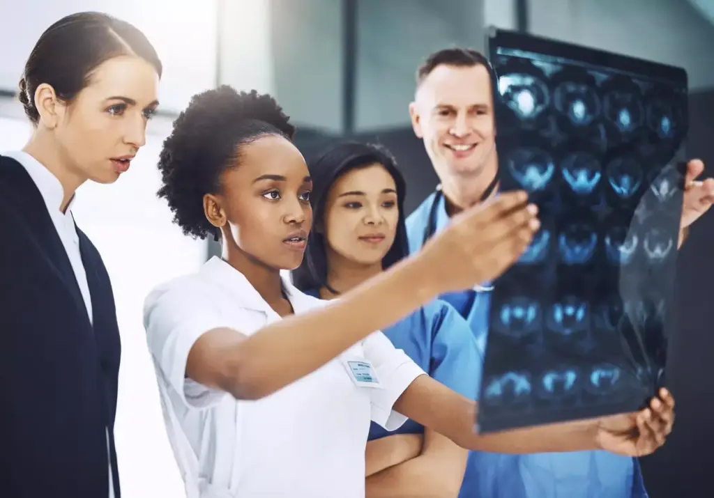 A team of medical professionals reviews imaging scans for treatment planning 