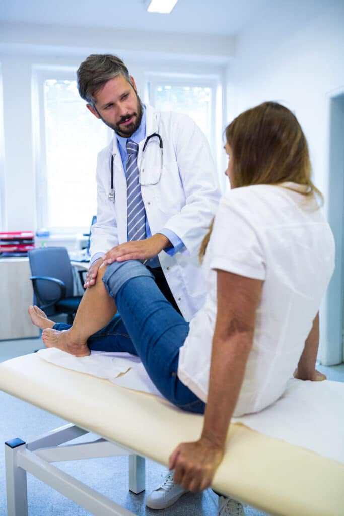 male-doctor-examining-patients-knee