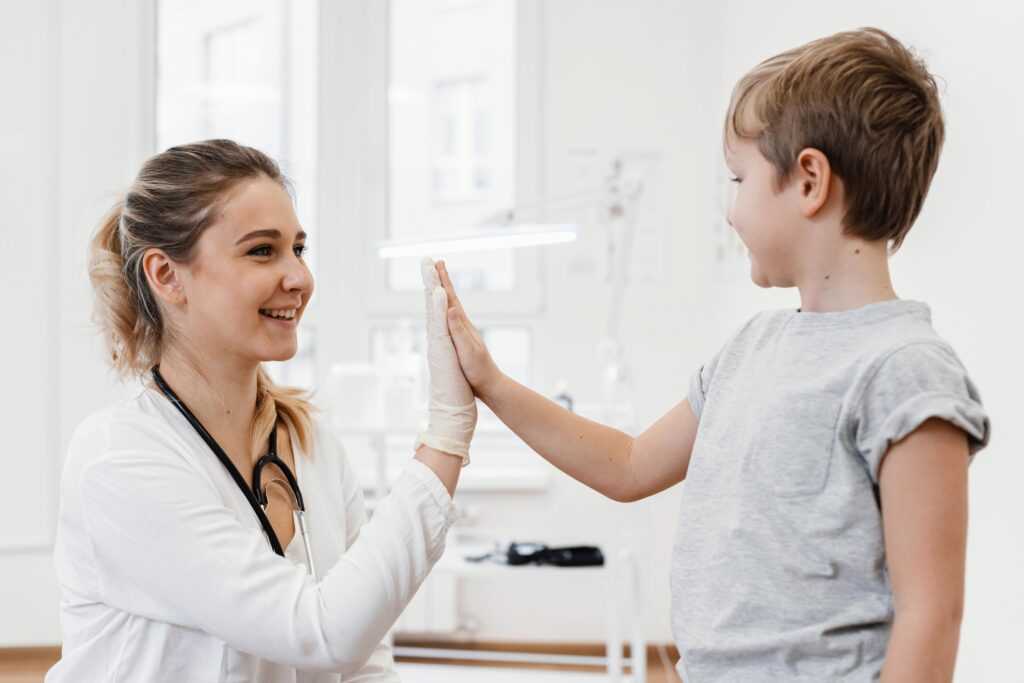 medium shot doctor kid high fiving LIV Hospital